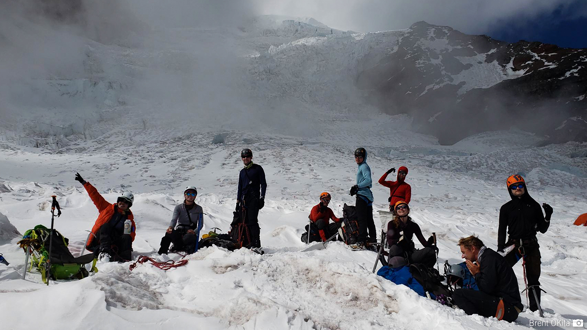 An RMI team taking a rest break at Ingraham Flats on Mt. Rainier during their descent.